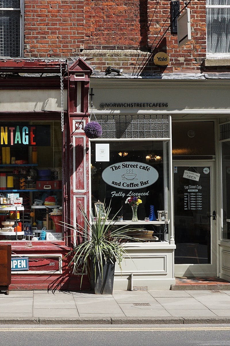 Vintage shop and cafe in Norwich showcasing eclectic storefronts and vibrant signage.